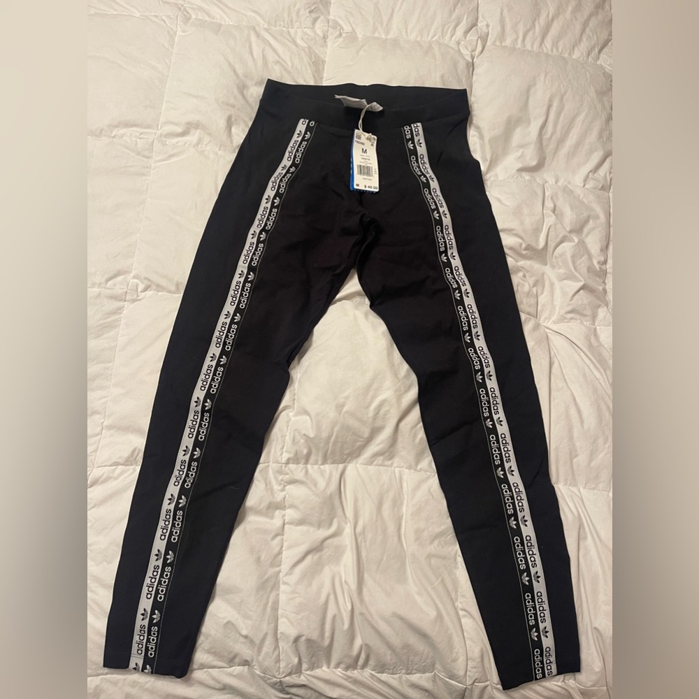 Size medium Adidas tights. Never worn, black